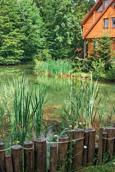 Beautiful wooden house on lake in wood