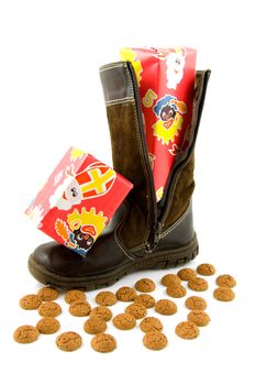 Boot with present and ginger nuts for typical Dutch event: Sinterklaas. Over white background