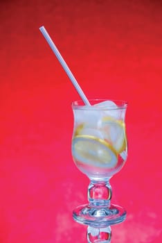 cold fresh with ice lemonade  on  red background
