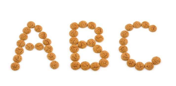 Ginger nuts, pepernoten, in the shape of letters A,B,C isolated on white background. Typical Dutch candy for Sinterklaas event in december.