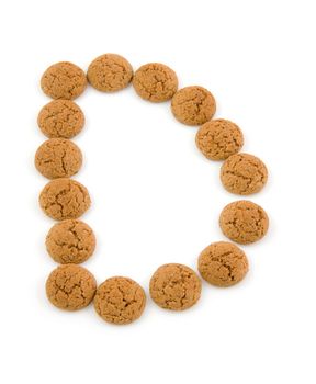 Ginger nuts, pepernoten, in the shape of letter D isolated on white background. Typical Dutch candy for Sinterklaas event in december.