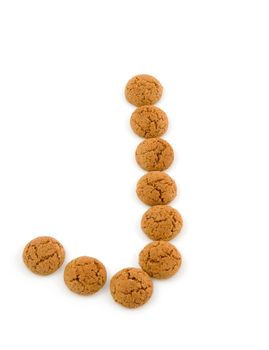 Ginger nuts, pepernoten, in the shape of letter J isolated on white background. Typical Dutch candy for Sinterklaas event in december.