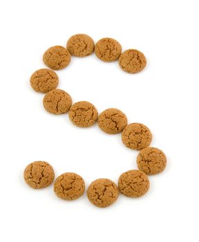 Ginger nuts, pepernoten, in the shape of letter S isolated on white background. Typical Dutch candy for Sinterklaas event in december.