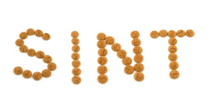 Ginger nuts, pepernoten, in the shape of word Sint isolated on white background. Typical Dutch candy for Sinterklaas event in december.