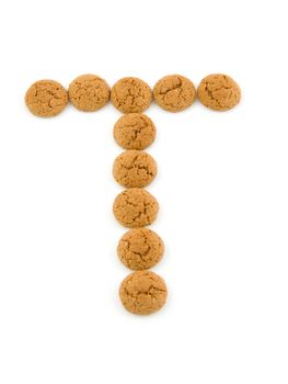 Ginger nuts, pepernoten, in the shape of letter T isolated on white background. Typical Dutch candy for Sinterklaas event in december.