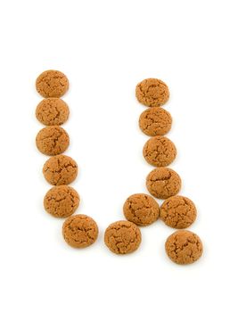 Ginger nuts, pepernoten, in the shape of letter U isolated on white background. Typical Dutch candy for Sinterklaas event in december.