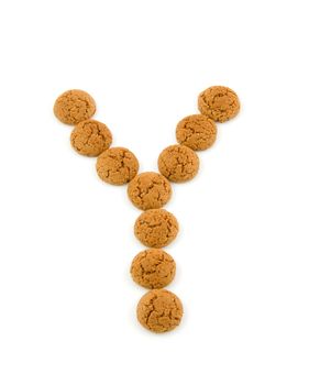 Ginger nuts, pepernoten, in the shape of letter Y isolated on white background. Typical Dutch candy for Sinterklaas event in december.