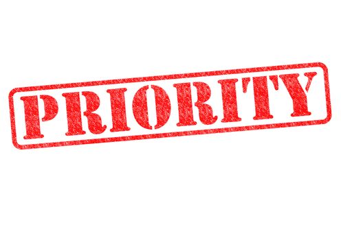 PRIORITY red rubber stamp over a white background.