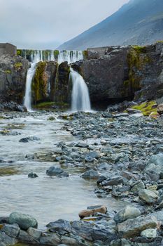 Waterfall in Iceland, landscape with beautiful nature. Vertical view