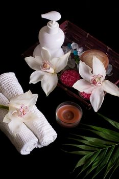 White orchids, spa treatment in wooden box isolated on black