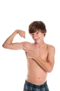 Young teen boy flexing and point at bicep with funny smirk.  Isolated on white background.