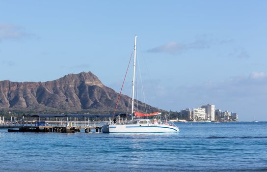 Boat docked in front of Diamond Head and Waikiki Beach area of Oahu in Hawaii