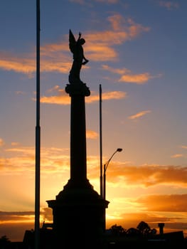 Warrnambool, Australia - August 16, 2005: The Warrnambool War Memorial commemorates Australian veterans who served their country.  Seen here is the angel on the top part of the monument silhouetted against the sunset.