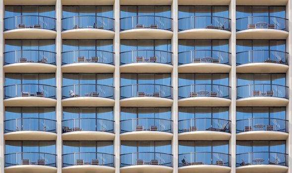 Pattern of hotel room balconies in modern building with all door closed and regular