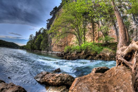 A High Dynamic Range photo of a rushing natural spring flowing into the lake of the ozarks in Missouri.