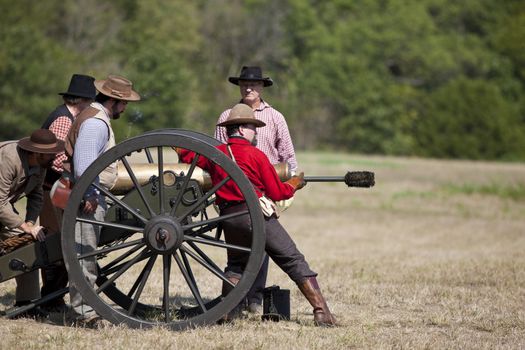 Battlefield, Missouri, USA - August 11, 2012: Civil war re-enactors prepare to fire off a cannon at Wilson's Creek National Battlefield Park in Battlefield, MO. Wilson's Creek was the first major Civil War battle fought west of the Mississippi River, and the scene of the death of general Nathaniel Lyon.