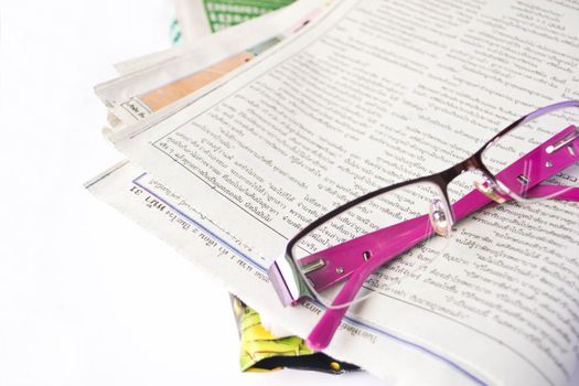 glasses on a newspaper