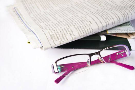 glasses on a newspaper