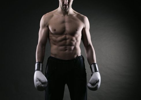 Male fighter posing in front of a dark background