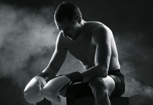 Boxer man concentrating on dark background