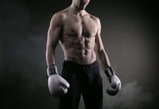 Male fighter posing in front of a dark background