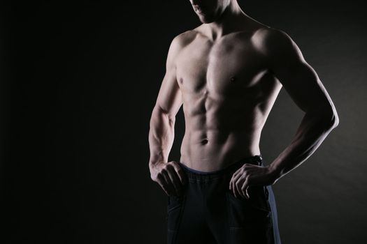 Sexy muscular man on dark background