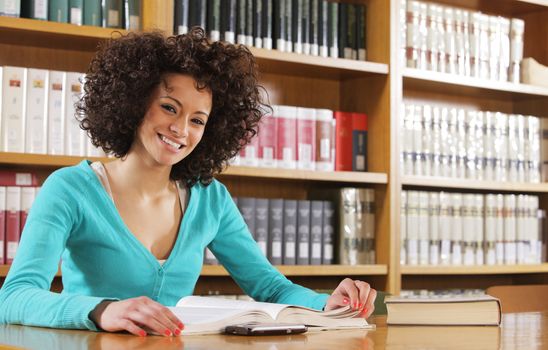 Portrait of cheerful student in library