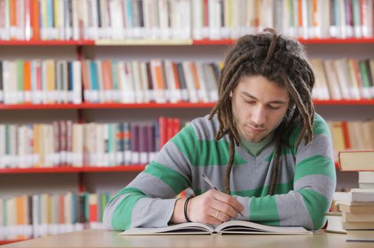 Young male student in the library, studying