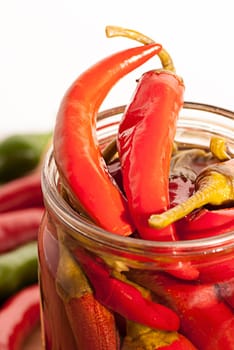 Preserved red hot chili peppers on white background