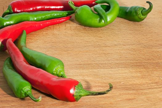 hot chili peppers on on wood board