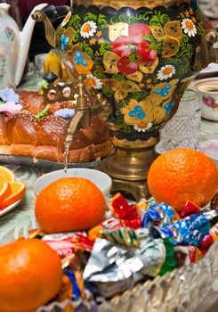 Russian samovar on a table with sweets