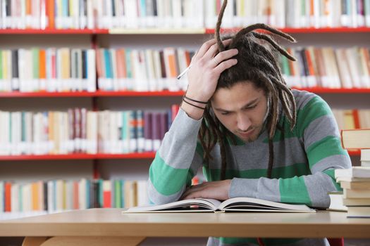 Student sitting in the library and working hardly