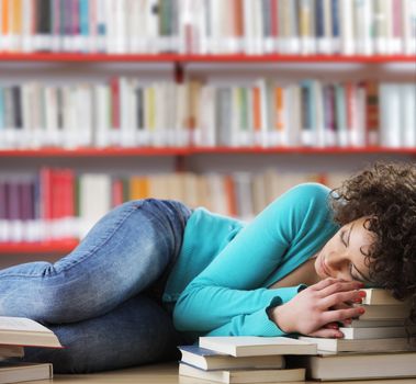 Student sleeping on desk in the library
