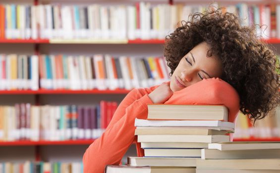 Student sleeping on desk in the library
