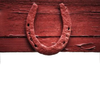 The old horseshoe hanging on wooden wall on a white background