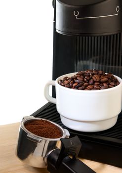 Close up coffee maker machine with white coffee cup and coffe bean