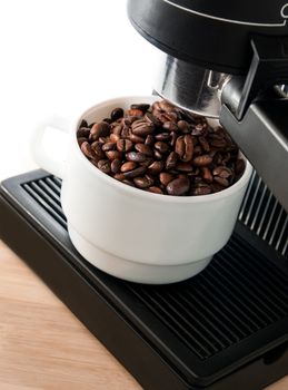 Close up coffee maker machine with white coffee cup and coffe bean