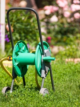equipment to watering the garden against the backdrop of a flourishing lawn
