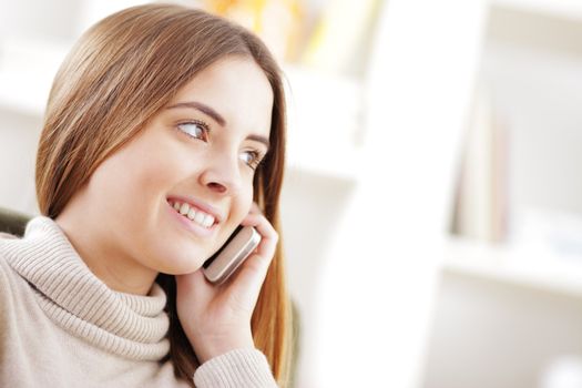 Beautiful young woman talking on cell phone