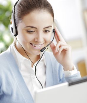 Young girl chating on laptop with headset