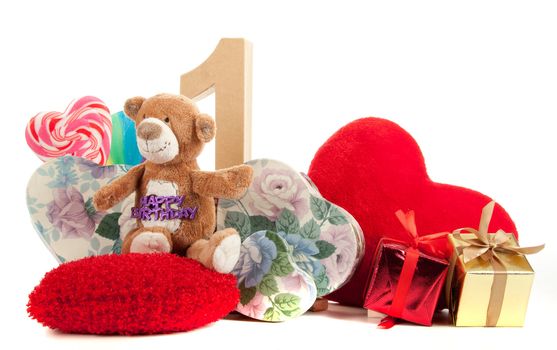 Number of age in a colorful studio setting with heart and gifts and yellow roses