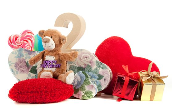 Number of age in a colorful studio setting with heart and gifts and yellow roses