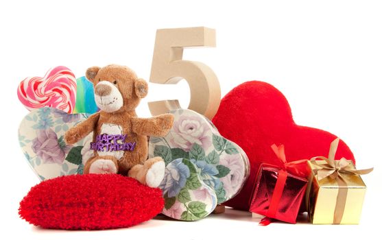 Number of age in a colorful studio setting with heart and gifts and yellow roses