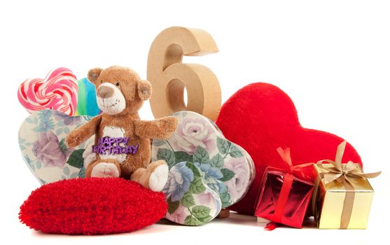 Number of age in a colorful studio setting with heart and gifts and yellow roses