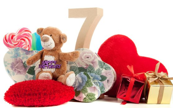 Number of age in a colorful studio setting with heart and gifts and yellow roses