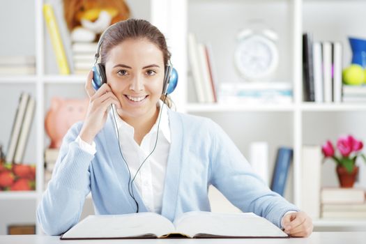 Portrait of a beautiful female college student with headphones