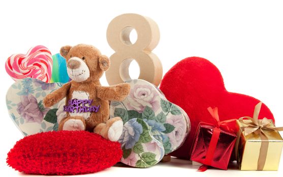 Number of age in a colorful studio setting with heart and gifts and yellow roses