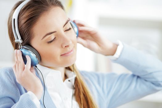 Woman wearing headphones, listening to music