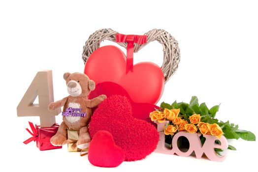 Number of age in a colorful studio setting with heart and gifts and yellow roses
