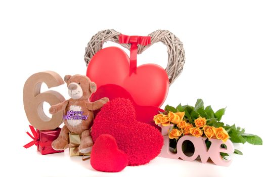 Number of age in a colorful studio setting with heart and gifts and yellow roses